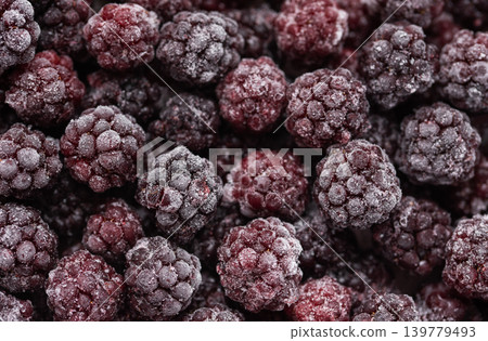 Frozen blackberries covered in frost creating a winter food background Frozen blackberries covered in frost creating a winter food background 139779493