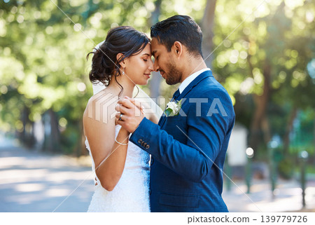 Forehead, holding hands and couple at wedding outdoor for marriage, love or dance in nature. Bride, groom and embrace for affection, people or partner for support and connection with peace in park Forehead, holding hands and couple at wedding outdoor for marriage, love or dance in nature. Bride, groom and embrace for affection, people or partner for support and connection with peace in park 139779726