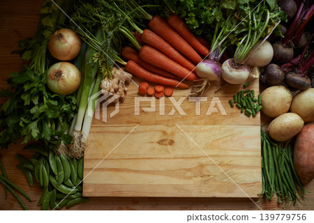 Vegetables, kitchen and empty cutting board for healthy food, cooking and preperation on table above. Culinary, organic and green groceries for vegan or vegetarian recipe and ingredients background Vegetables, kitchen and empty cutting board for healthy food, cooking and preperation on table above. Culinary, organic and green groceries for vegan or vegetarian recipe and ingredients background 139779756