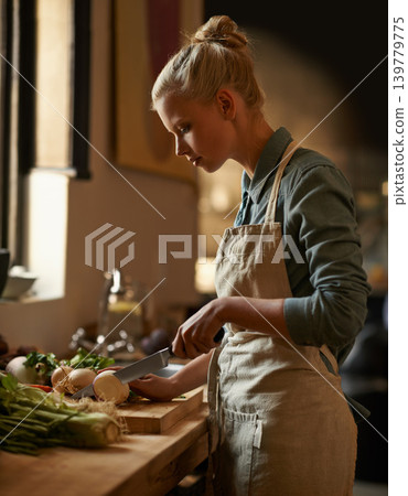 Cooking, woman and vegetables with knife in home with diet, nutrition and food with turnip. Kitchen, green and health from organic and vegan lunch with ingredients and wood board with wellness Cooking, woman and vegetables with knife in home with diet, nutrition and food with turnip. Kitchen, green and health from organic and vegan lunch with ingredients and wood board with wellness 139779775
