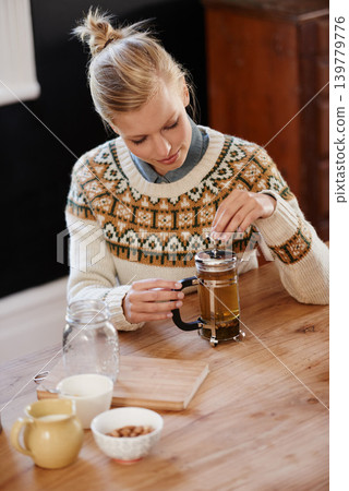 Woman, happy and herbal tea for calm in home and warm beverage of herbs mixture for health. Kitchen, person and detox with dry leaves in plunger and chamomile drink to relax in apartment in above Woman, happy and herbal tea for calm in home and warm beverage of herbs mixture for health. Kitchen, person and detox with dry leaves in plunger and chamomile drink to relax in apartment in above 139779776