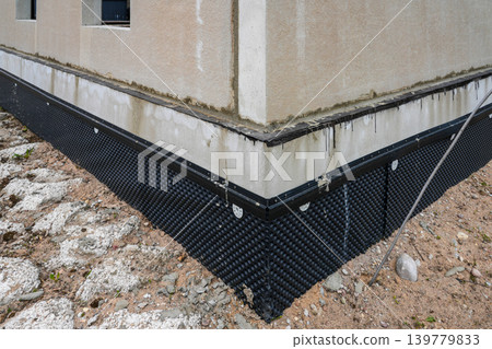 Foundation waterproofing membrane installed on modern residential building under construction site 139779833