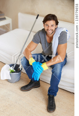 Man, house and cleaning with living room, break and portrait with happy, rest and smile. Husband, home and furniture for maintenance, housekeeping and spring cleaning for responsibility or routine Man, house and cleaning with living room, break and portrait with happy, rest and smile. Husband, home and furniture for maintenance, housekeeping and spring cleaning for responsibility or routine 139779858