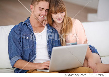 Happy, couple and relax with laptop on sofa to watch movies with subscription for streaming in home. Online, man and woman reading on couch and scroll the news on website, blog or social media 139779922