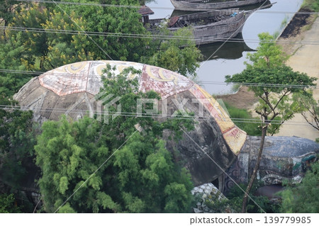 Giant Turtle Statue by River with Boats Giant Turtle Statue by River with Boats 139779985