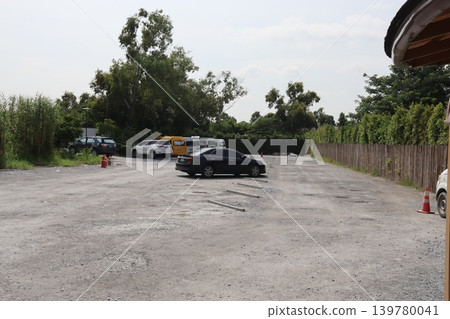 Outdoor Parking Lot with Vehicles and Greenery 139780041