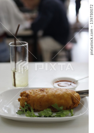Fried Pastry with Cilantro on Plate 139780072