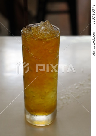 Orange Beverage with Ice in Glass Orange Beverage with Ice in Glass 139780078