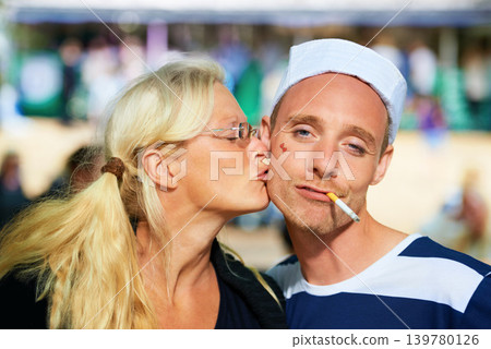 Couple, music festival and happiness with kissing, portrait or bonding together with weekend break. Face, people or friends with joy or concert with a party or outdoor with fun or costume with summer Couple, music festival and happiness with kissing, portrait or bonding together with weekend break. Face, people or friends with joy or concert with a party or outdoor with fun or costume with summer 139780126