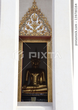 Golden Buddha Statue in Ornate Niche Golden Buddha Statue in Ornate Niche 139780164