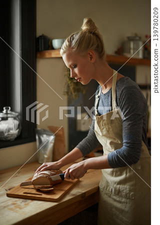 Bakery, kitchen and woman with knife on bread, cutting on board and cooking gluten free food for breakfast. Fresh, loaf and chef in restaurant with healthy rye in preparation process of brunch Bakery, kitchen and woman with knife on bread, cutting on board and cooking gluten free food for breakfast. Fresh, loaf and chef in restaurant with healthy rye in preparation process of brunch 139780209