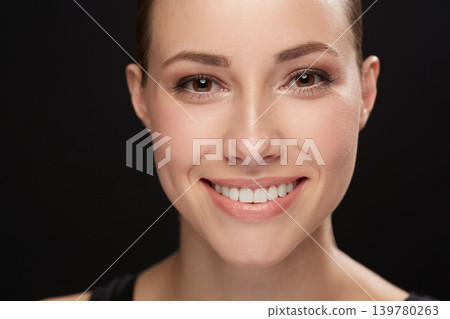 Model, happiness and portrait in studio with cosmetics, closeup and beauty results of cosmetology in mockup. Woman, face and skincare with retinol for glow, facial and make up on black background Model, happiness and portrait in studio with cosmetics, closeup and beauty results of cosmetology in mockup. Woman, face and skincare with retinol for glow, facial and make up on black background 139780263