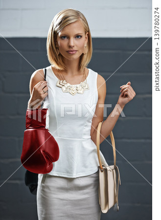 Woman, portrait and fashion with bags or boxing gloves or designer style with exercise equipment, confidence or beauty. Female person, face and workout gear for fighter cardio shopping or challenge Woman, portrait and fashion with bags or boxing gloves or designer style with exercise equipment, confidence or beauty. Female person, face and workout gear for fighter cardio shopping or challenge 139780274