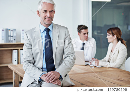 Happy, manager and portrait of businessman in office at meeting with team for corporate legal case. Smile, confident and senior male attorney ceo on table in workplace boardroom for law project. 139780296