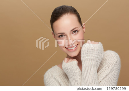 Winter, beauty or portrait of happy woman in studio isolated on brown background for fashion or wellness. Face, skincare glow or smile with confident model or natural person in wool jersey or sweater 139780299