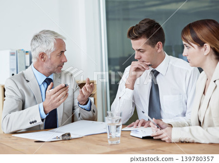 Business people, leader or planning on paperwork for collaboration, strategy or notes at office. Senior CEO, teamwork or employees with documents or report in meeting for brainstorming at workplace Business people, leader or planning on paperwork for collaboration, strategy or notes at office. Senior CEO, teamwork or employees with documents or report in meeting for brainstorming at workplace 139780357