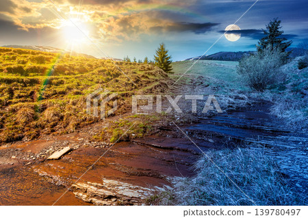 day meet night. rural scenery in carpathian mountains. sun and moon over simple view of a countryside mountain landscape during springtime at twilight. brook near the grassy hills. harmony concept 139780497