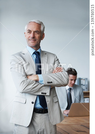 Senior businessman, professional and confidence in leadership, agency and pride for mentoring in office. Male person, arms crossed and smile for support in management, advisor and laptop for planning Senior businessman, professional and confidence in leadership, agency and pride for mentoring in office. Male person, arms crossed and smile for support in management, advisor and laptop for planning 139780515