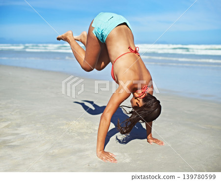 Handstand, beach and woman with vacation, fitness and summer with adventure and movement. Person, seaside and girl with activity or holiday with journey and sunshine with workout or excited with trip 139780599