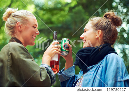 Friends, cheers and drinks at music festival in forest, excited and beer for bonding together by trees. Women, drinking and celebration in summer on holiday adventure and reunion by concert in woods 139780617