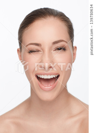 Portrait, smile and woman wink for skincare, flirt or beauty makeup isolated on white studio background. Face, blink and happy model in cosmetics excited for spa facial treatment for healthy skin Portrait, smile and woman wink for skincare, flirt or beauty makeup isolated on white studio background. Face, blink and happy model in cosmetics excited for spa facial treatment for healthy skin 139780634