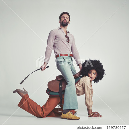 Vintage, man and woman or riding crop in studio with piggyback, portrait and funny face for retro style. Friends, people and 70s outfit with hipster clothes or comic expression with white background 139780657