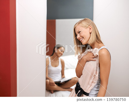 Women, friends and dress in bedroom, decision and mirror at home for style and beauty. Female, smile and fashion to show, wear and impress for agency or excited for appointment classy event or date 139780750