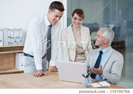 Laptop, meeting and business people in discussion in office for corporate legal project. Conversation, technology and professional team of lawyers working on computer by desk together in workplace. 139780766