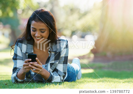 Grass, phone or happy woman in park for social media to chat on internet post or website notification. Nature, smile or female person on mobile app for texting, networking or typing online to relax Grass, phone or happy woman in park for social media to chat on internet post or website notification. Nature, smile or female person on mobile app for texting, networking or typing online to relax 139780772