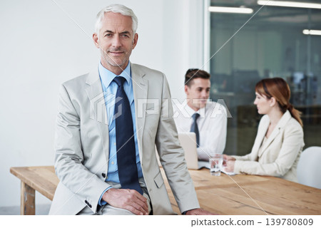 Smile, manager and portrait of businessman in office at meeting with team for corporate legal case. Happy, confident and senior male attorney ceo on table in workplace boardroom for law project. Smile, manager and portrait of businessman in office at meeting with team for corporate legal case. Happy, confident and senior male attorney ceo on table in workplace boardroom for law project. 139780809