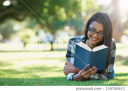 Happy woman, student and reading book in nature for literature, studying or story on green grass. Female person, smart or young adult with smile or glasses for chapter, learning or outdoor education Happy woman, student and reading book in nature for literature, studying or story on green grass. Female person, smart or young adult with smile or glasses for chapter, learning or outdoor education 139780811