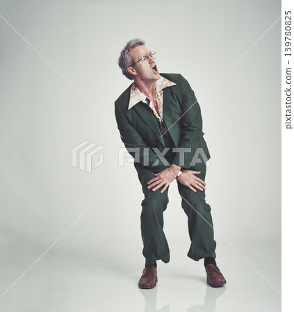 Retro, fashion and man dancing in studio happy attitude, fun and groovy suit on mockup space. Funky clothes, playful and mature person with vintage style, unique and excited on white background. Retro, fashion and man dancing in studio happy attitude, fun and groovy suit on mockup space. Funky clothes, playful and mature person with vintage style, unique and excited on white background. 139780825