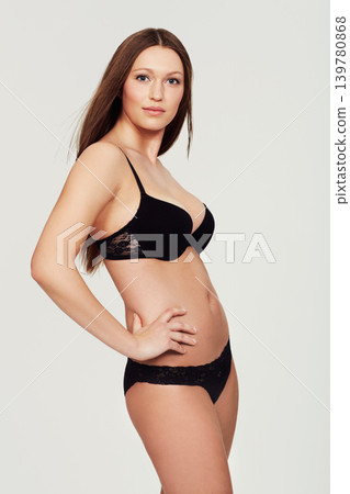 Portrait, woman and healthy body with lingerie in studio for wellness, bodycare or confidence on white background. Face, attitude and female model posing in underwear with smooth skin, beauty or glow 139780868