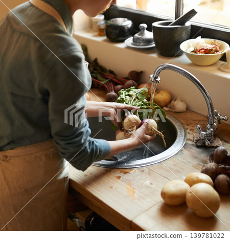 Hands, basin and water to clean vegetables in kitchen, health and hygiene with chef cooking food and catering. Turnip, nutrition with organic vegan or vegetarian meal with person washing produce 139781022