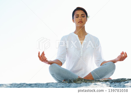 Woman, meditation and yoga in zen for spiritual wellness, awareness or outdoor beach with sky background. Calm female person or yogi meditating for inner peace, breathing or health on mockup space Woman, meditation and yoga in zen for spiritual wellness, awareness or outdoor beach with sky background. Calm female person or yogi meditating for inner peace, breathing or health on mockup space 139781038