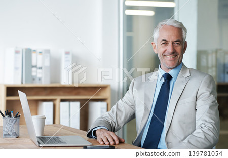 CEO, businessman and laptop at desk, portrait and work for lawyer firm. Senior executive, office and smile at company, suit and success in corporate workspace for attorney and insurance lawyers CEO, businessman and laptop at desk, portrait and work for lawyer firm. Senior executive, office and smile at company, suit and success in corporate workspace for attorney and insurance lawyers 139781054