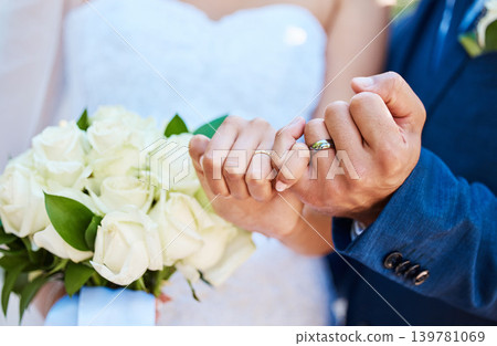 Hands, couple and wedding ring with pinky promise at ceremony for commitment, loyalty and love vow. People, bride and groom with jewelry at event for marriage celebration, bouquet and eternal union Hands, couple and wedding ring with pinky promise at ceremony for commitment, loyalty and love vow. People, bride and groom with jewelry at event for marriage celebration, bouquet and eternal union 139781069