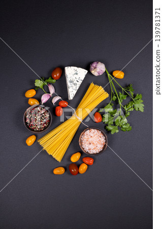 Raw spaghetti pasta ingredients and fresh vegetables flat lay Raw spaghetti pasta ingredients and fresh vegetables flat lay 139781371