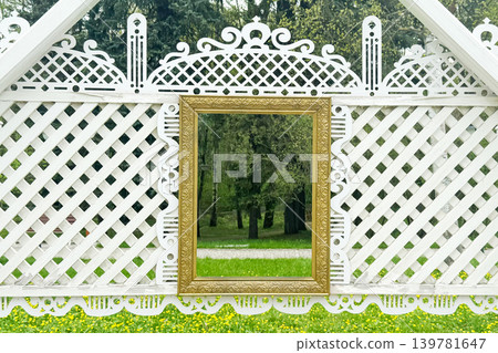 Ornate White Garden Pavilion Wall with Decorative Golden Frame and Park View Ornate White Garden Pavilion Wall with Decorative Golden Frame and Park View 139781647