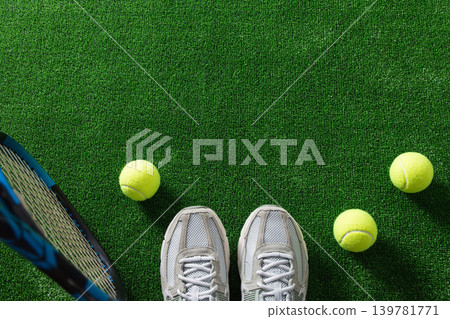Tennis shoes racket and balls on green court background Tennis shoes racket and balls on green court background 139781771