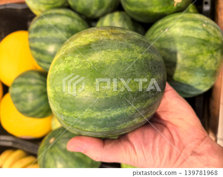 Freshly picked watermelon at a bustling market during a sunny afternoon Freshly picked watermelon at a bustling market during a sunny afternoon 139781968