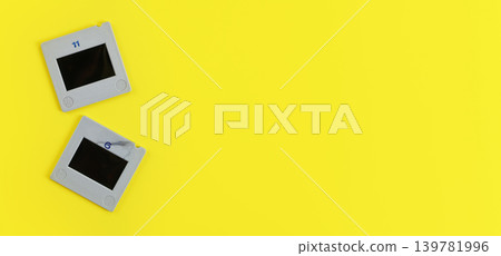 Two diapositive photo slides on yellow table, view from above, space for text right side, retro photography concept Two diapositive photo slides on yellow table, view from above, space for text right side, retro photography concept 139781996