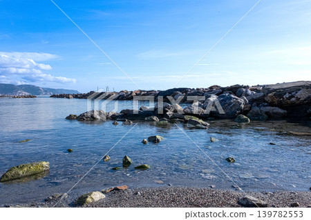 Open Sea Stretching Toward Rugged Coastal Rock Formation Open Sea Stretching Toward Rugged Coastal Rock Formation 139782553