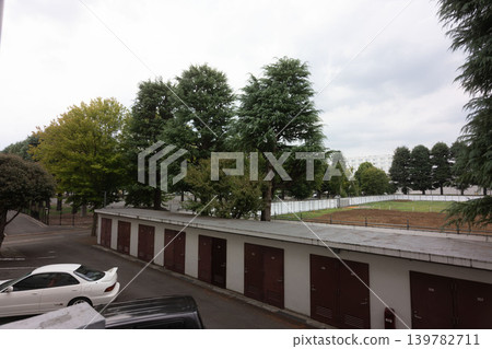 A retro Showa-era atmosphere: A nostalgic public housing complex nestled in a lush green area. 139782711