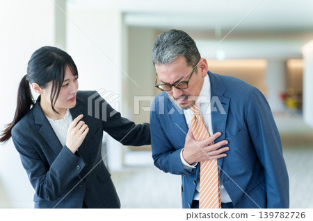 Businessman suffering from holding his chest Businessman suffering from holding his chest 139782726