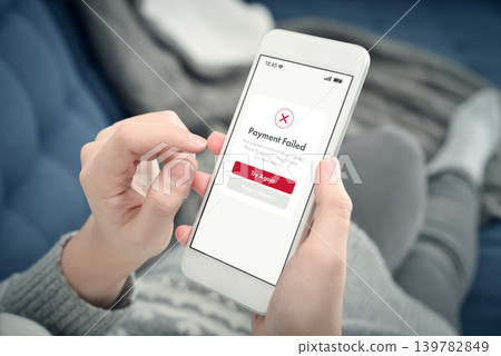 Failed online payment on smartphone screen in woman hands at home 139782849