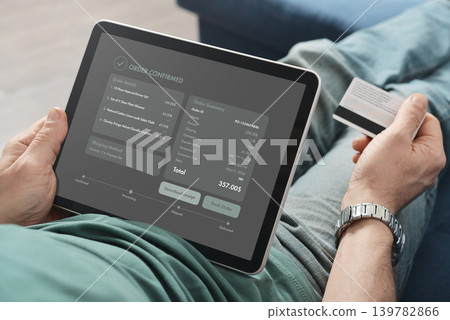 Man Holding Tablet with Order Confirmation Screen at Home 139782866