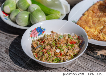 Traditional spicy fish dip served fresh vegetables omelet on rustic wooden table featuring local cuisine homemade flavors 139783453