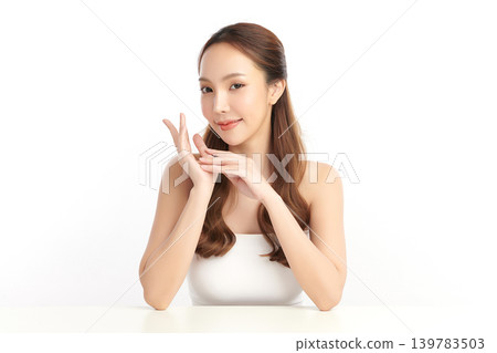 A beautiful young Asian woman with clean, fresh skin against a white background. Skincare, facial treatment, cosmetology, beauty, and spa. An elegant portrait of an Asian woman. 139783503