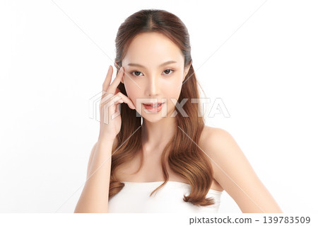 A beautiful young Asian woman with clean, fresh skin against a white background. Skincare, facial treatment, cosmetology, beauty, and spa. An elegant portrait of an Asian woman. A beautiful young Asian woman with clean, fresh skin against a white background. Skincare, facial treatment, cosmetology, beauty, and spa. An elegant portrait of an Asian woman. 139783509